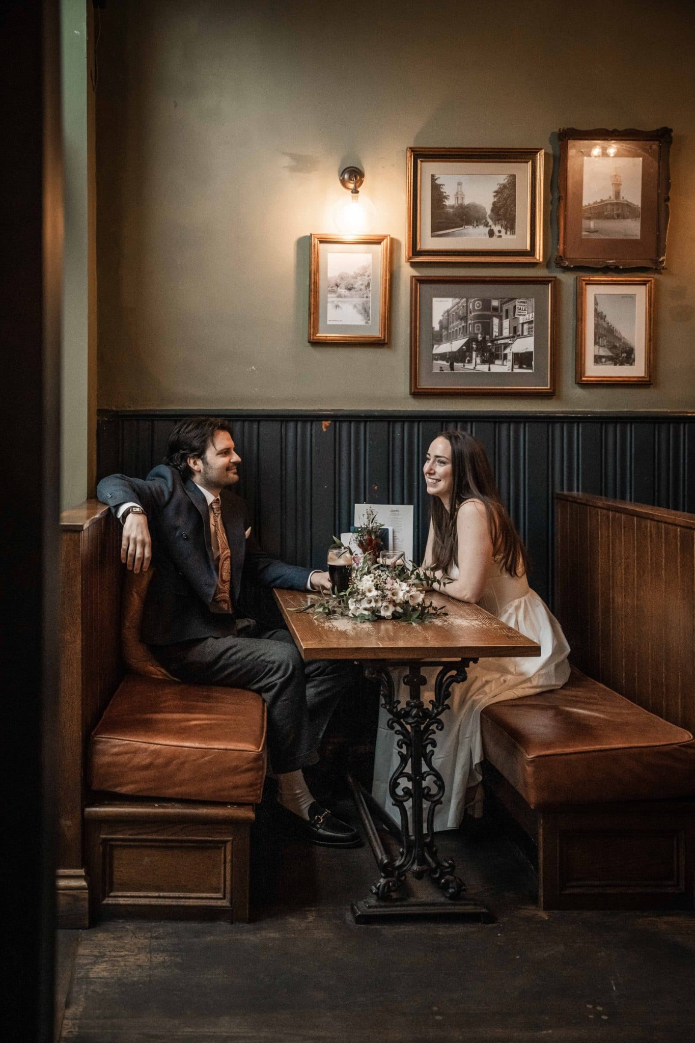 Bride and groom seated together in an intimate pub setting