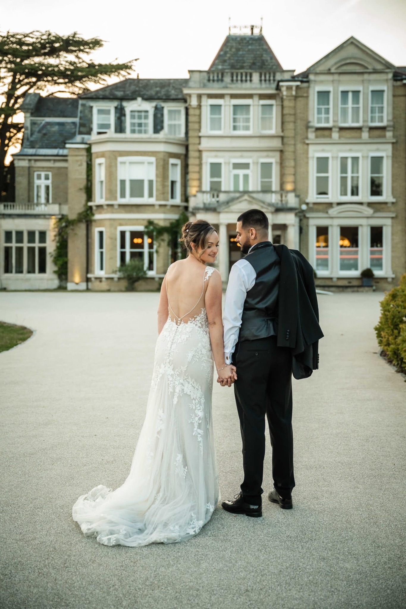 Newlyweds walking outside a country house