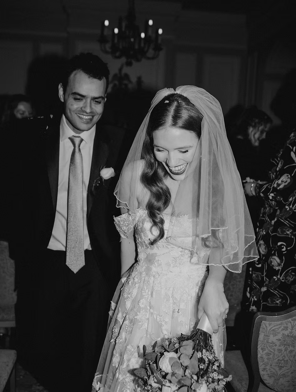 Joyful newlyweds in a candid black and white wedding moment