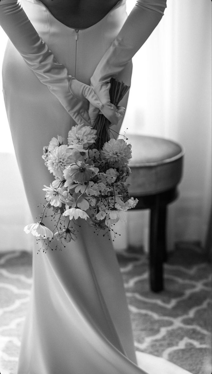 Black and white bridal portrait holding a loose floral bouquet