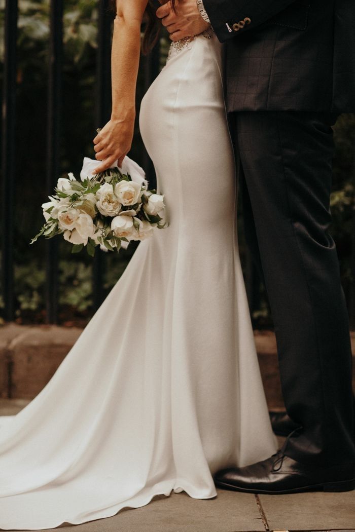 Elegant bride and groom portrait with a white wedding bouquet