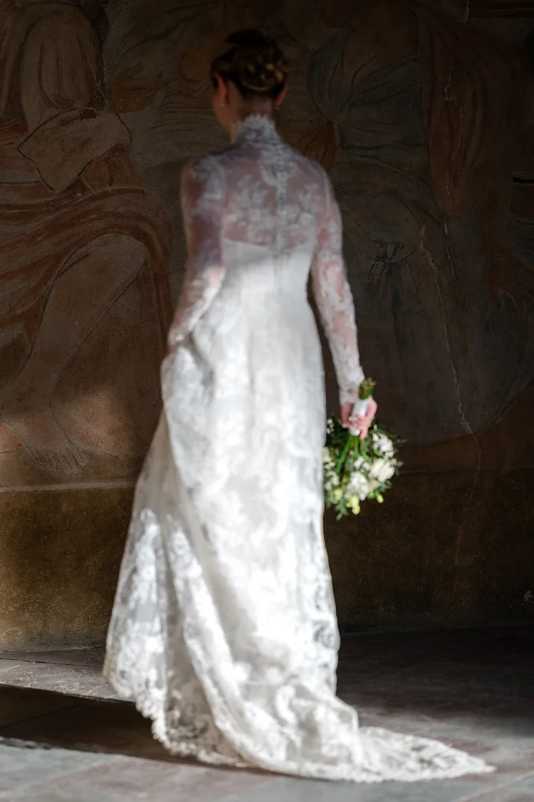 Bride in a lace wedding dress photographed in soft directional light