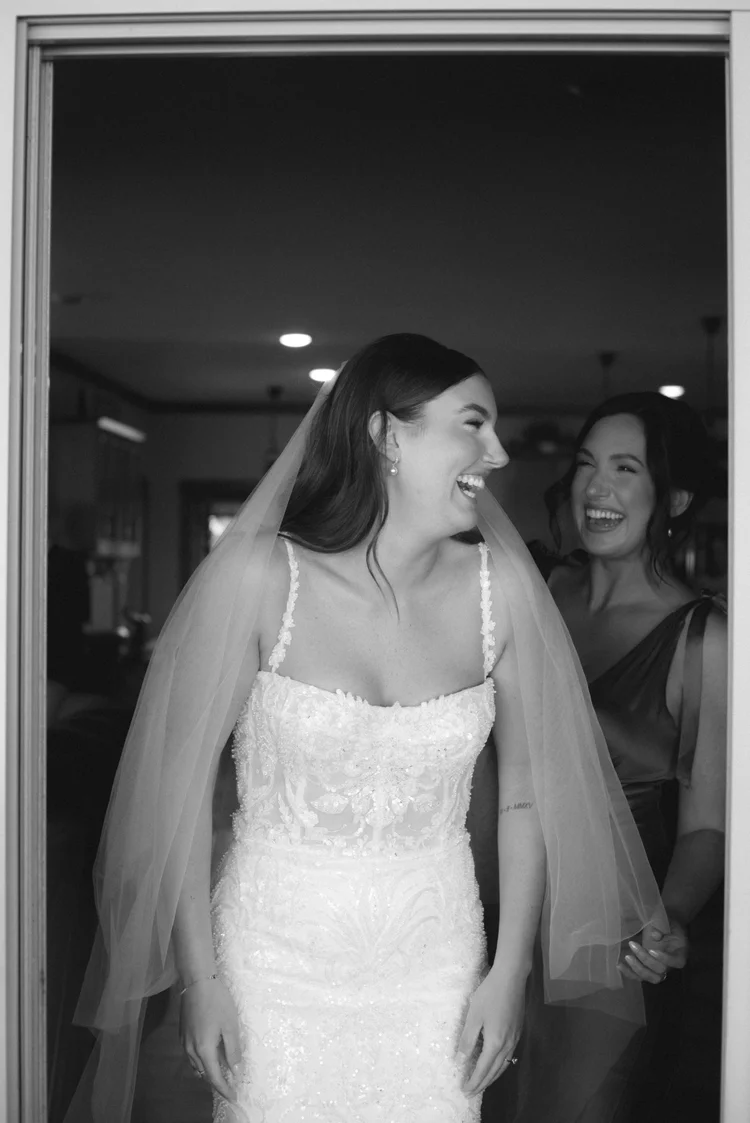 Bride laughing while getting ready