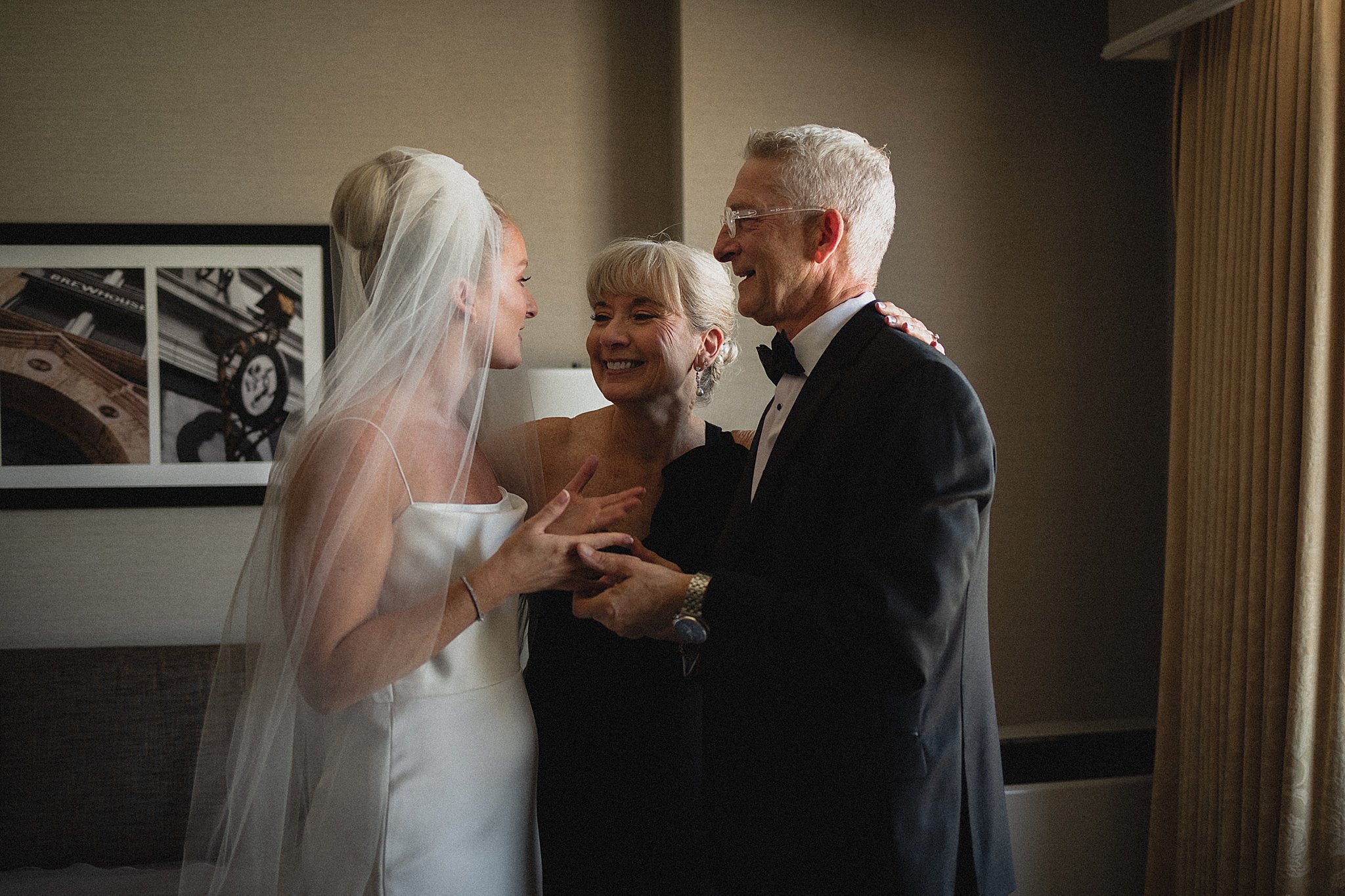 Bride sharing an emotional moment with her parents before the ceremony