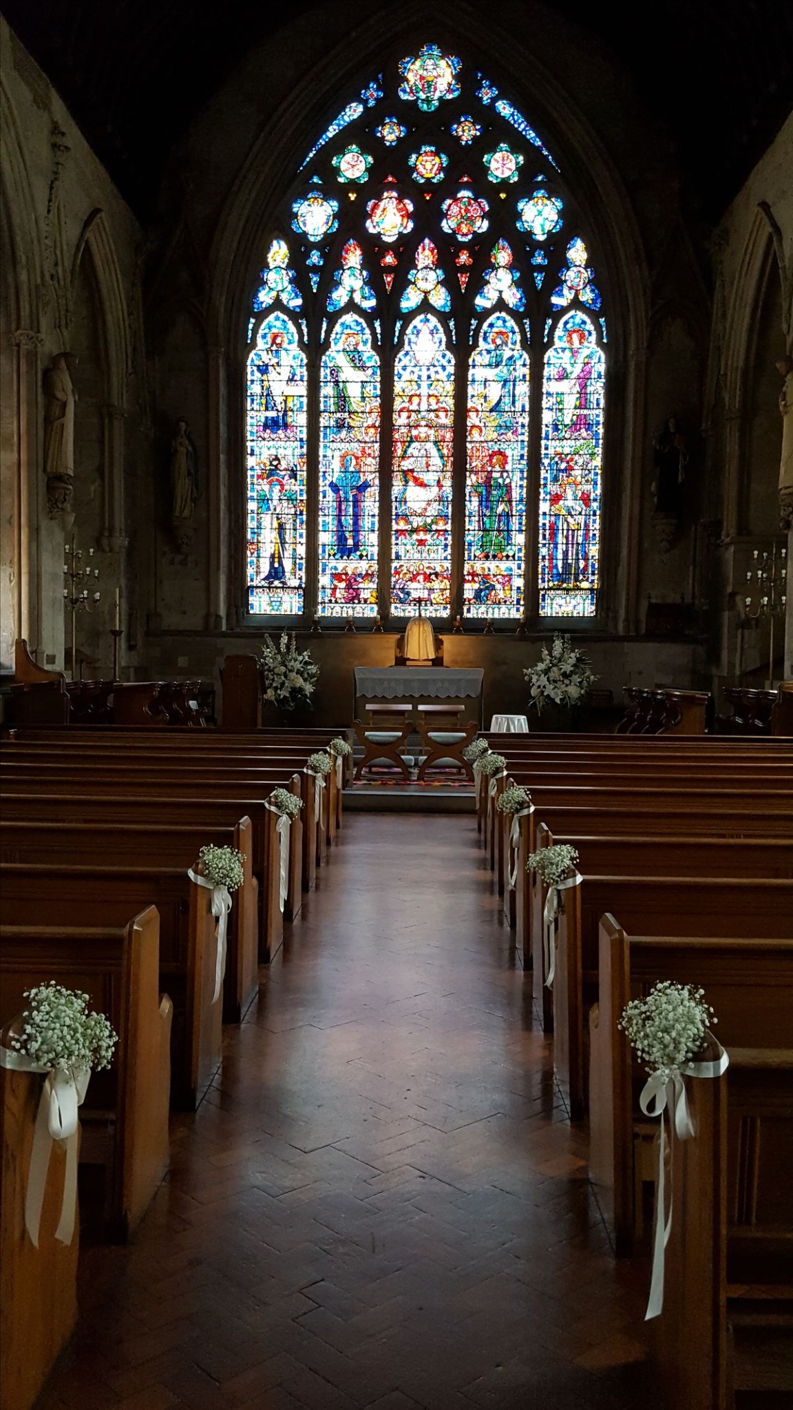 Historic church wedding ceremony setting with stained glass in Ireland