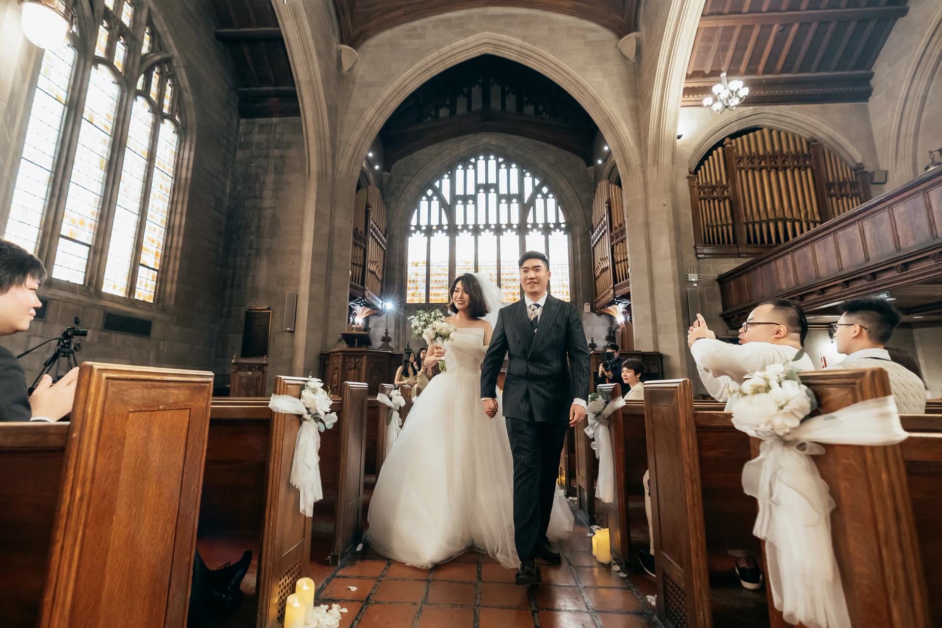 Bride and groom walking down the aisle in a historic church