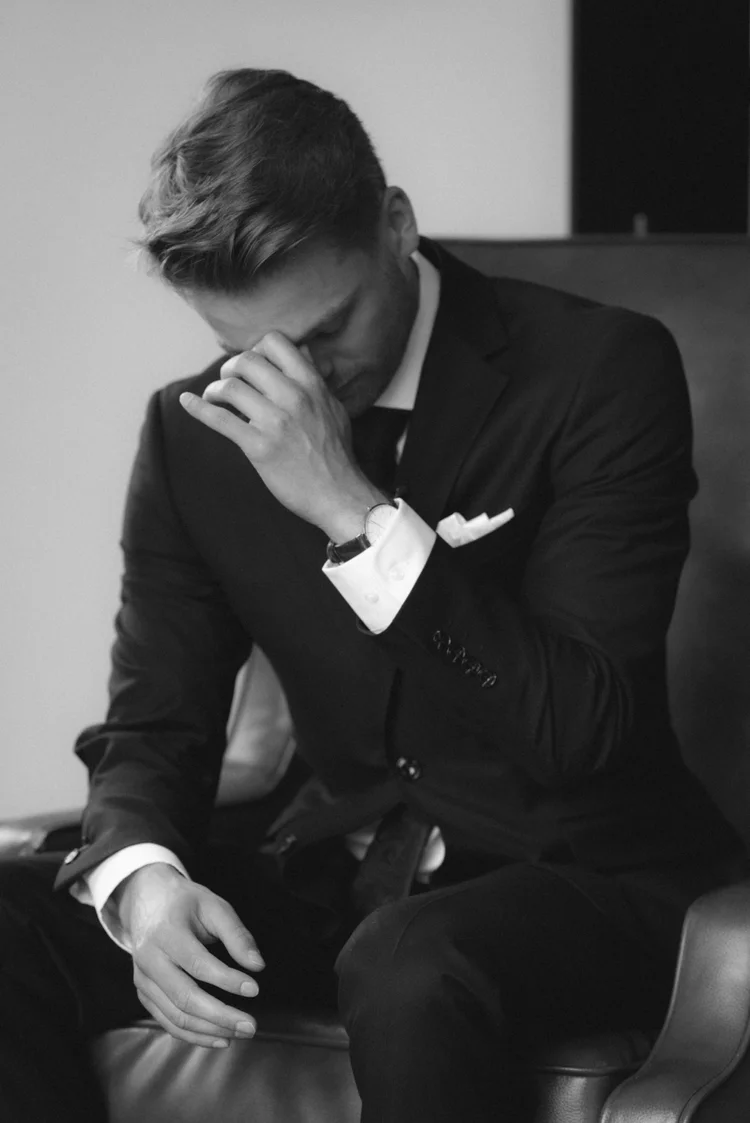 Emotional groom getting ready