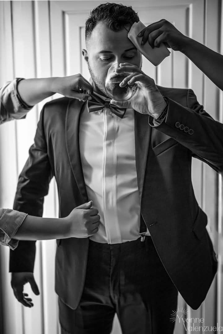 Candid black and white groom preparation moment before the ceremony