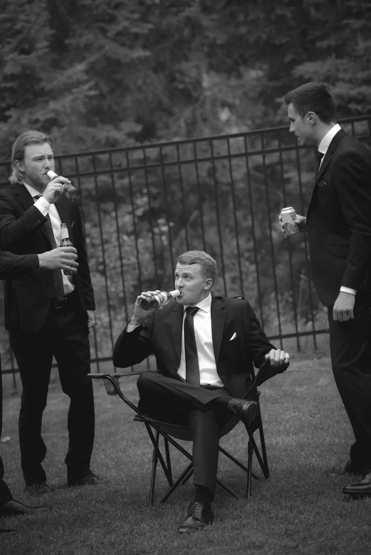 Groomsmen sharing drinks before the wedding