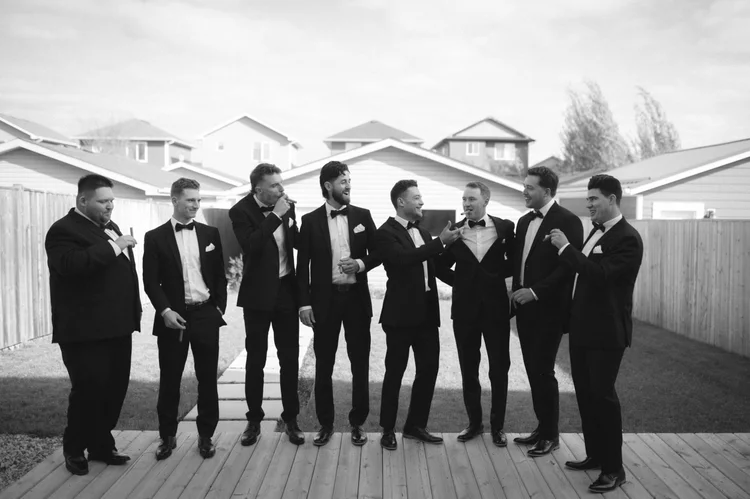 Groomsmen sharing a candid moment before the wedding
