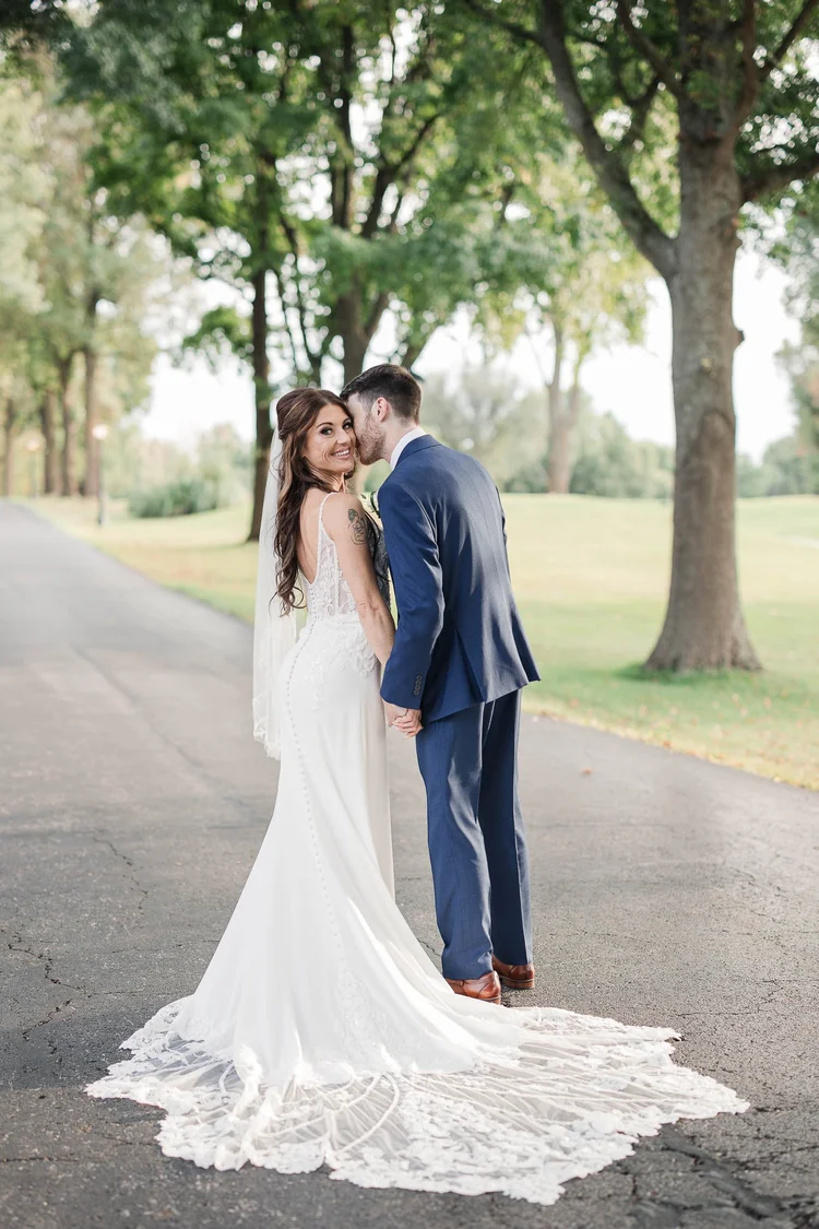 Bride and groom walking together on a quiet country road