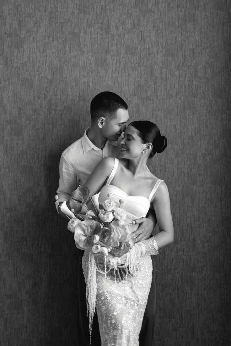Elegant black and white editorial portrait of newlyweds with flowers