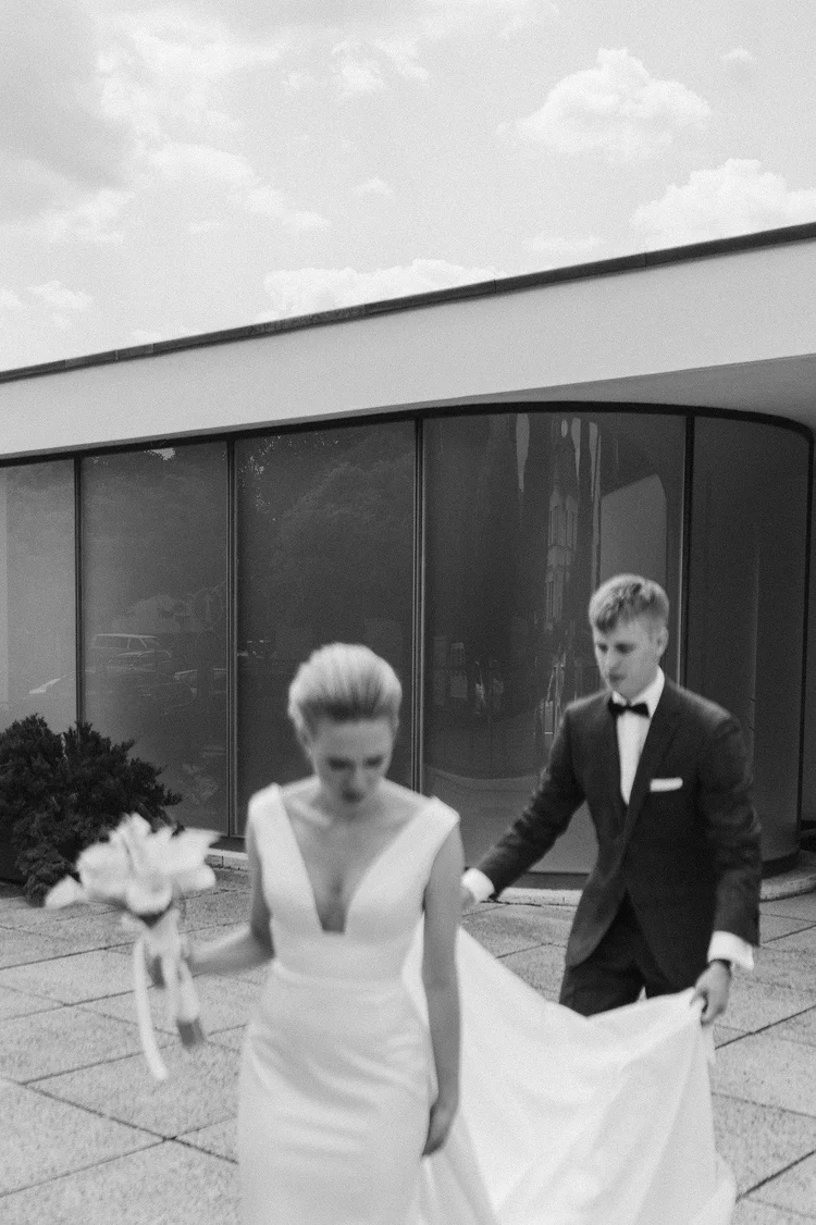 Black and white newlywed portrait outside a modern wedding venue