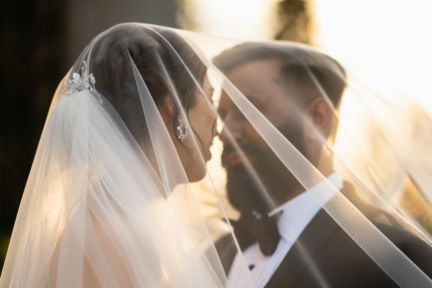 Wedding couple outside an illuminated manor at night