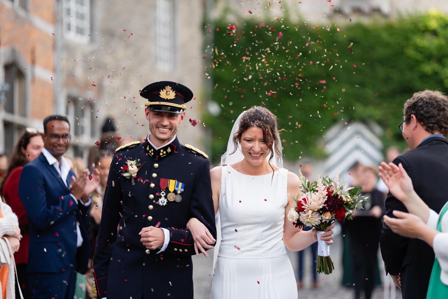 Newlyweds with a red vintage wedding car
