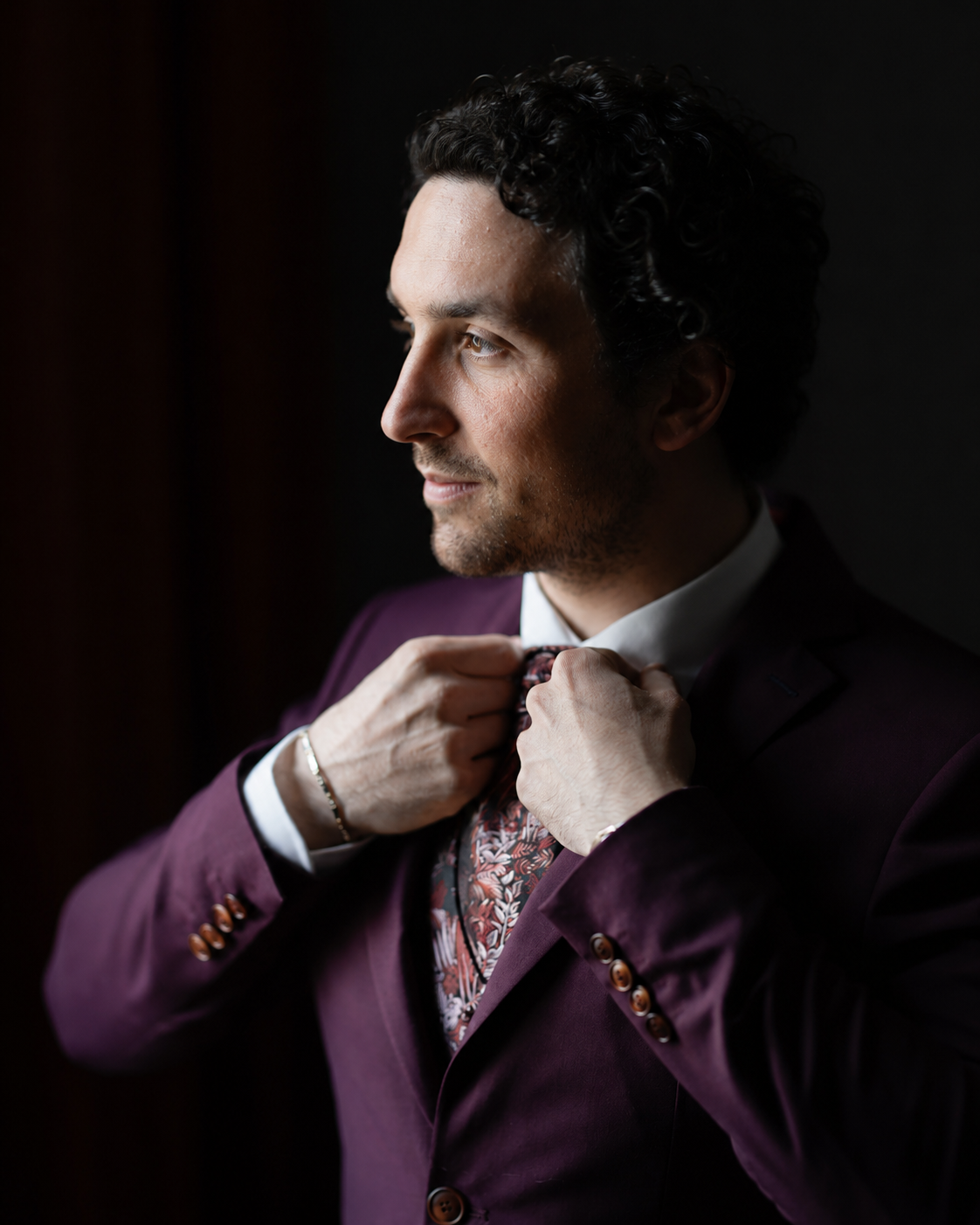 Portrait of Thibault adjusting his tie